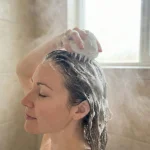 shampoo brush in use by a woman in shower